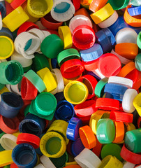 Colorful plastic bottlecaps closeup. Recycling and industry concept.