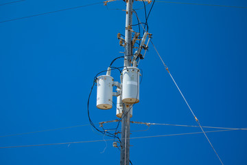 Electric pole with a transformer and wires