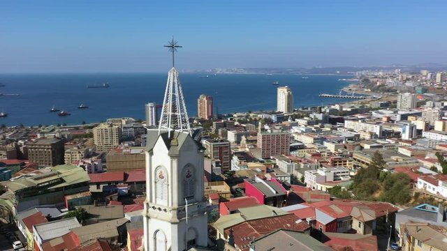 Aerial drone view of Iglesia de los Doce Apostoles old church and colourfully decorated houses on the hills of the historic port city of Valparaiso, Chile