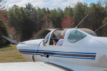 Active Senior Man getting ready for takeoff by programming his flight plan