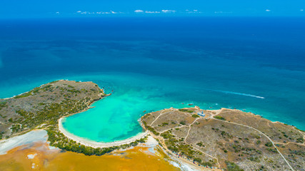 Fototapeta na wymiar Aerial view of Puerto Rico. Faro Los Morrillos de Cabo Rojo. Playa Sucia beach and Salt lakes in Punta Jaguey. 