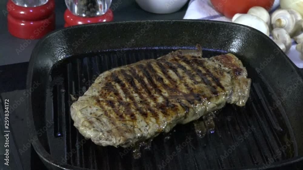 Sticker delicious rib steak grilling in a cast iron grill