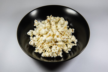 Popcorn in a plate on white background