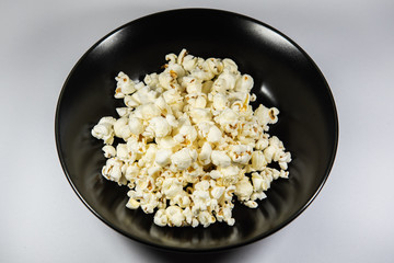 Popcorn in a plate on white background