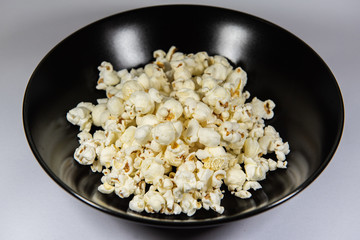 Popcorn in a plate on white background