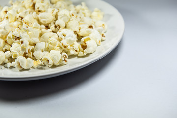 Popcorn in a plate on white background