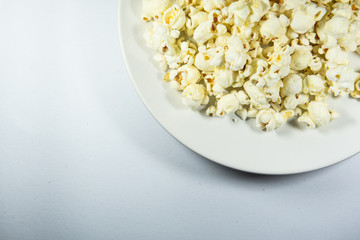 Popcorn in a plate on white background