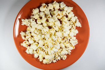 Popcorn in a plate on white background