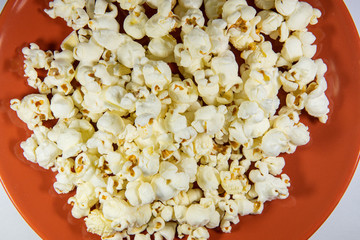 Popcorn in a plate on white background