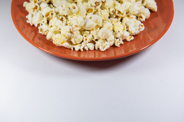 Popcorn in a plate on white background