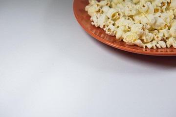 Popcorn in a plate on white background
