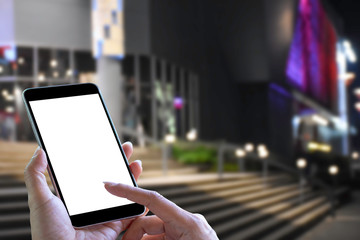 Mockup female hand use blank screen mobile smartphone on shopping mall blurred background. 