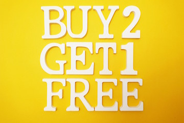 Buy Two Get One Free Sale Promotion on Yellow background