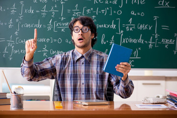 Funny male math teacher in the classroom 