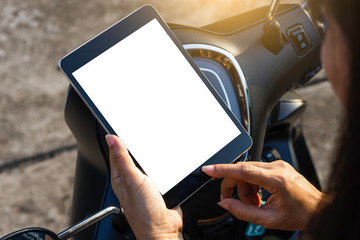 Woman on motorcycle use digital tablet for gps app[ication.