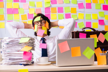 Young employee in conflicting priorities concept 