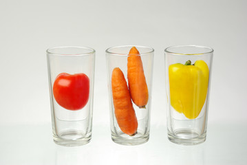 Vegetable juices. Tomato, carrot and sweet pepper in empty glasses. Juice concept