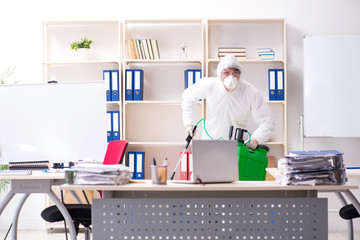 Professional contractor doing pest control at office 