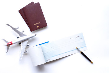 Mockup image of cheque book,pen, passport and airplane model isolated on white background.. Trip...