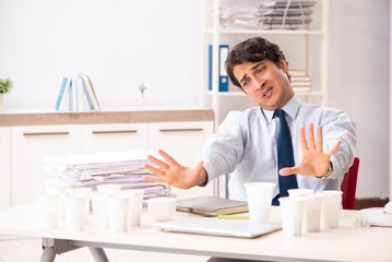 Young employee addicted to coffee