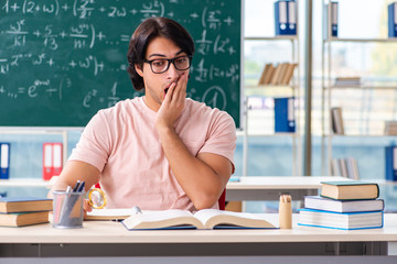 Young male student in the classroom 