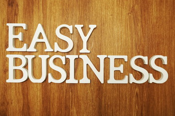 Easy Business word alphabet letters on wooden background