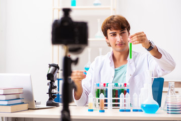 Fototapeta premium Chemist blogger recording video for his blog