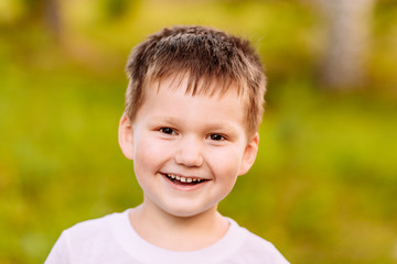 the five-year child smiling on blurred background