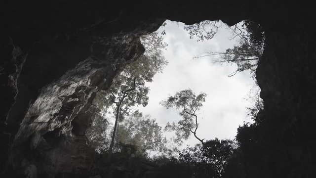 Cave of Mountain on Top Against Blue Sky, Sunlight Made Light and Dark on Rock, Wind Blowing and Movement of Plant and Tree with Colorless and Hi Speed 2500 fps. 