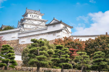 Fototapeta na wymiar Himeji Castle, shown here in autumn, is considered most beautiful castle in Japan and the prototype of classic medieval Japanese architecture. 