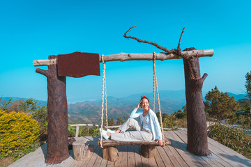 woman in holiday posing relaxing and freedom in outdoor nature on mountain with blue sky and sunlight by concept relax in vacation and holiday travel