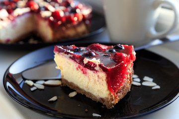 Cosy breakfast with a peace of berry cheesecake
