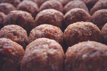 Many rows of freshly made meat balls ready for cooking