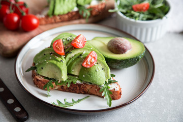 healthy breakfast with avocado and Delicious wholewheat toast. sliced avocado on toast bread with spices. Mexican cuisine