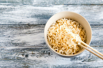 Instant noodles on wooden background. Cooked chinese instant noodles. Soup Ramen