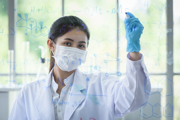 Asian young girl student scientist has writing and researching in laboratory.