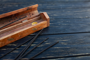 sandalwood sticks on a black wooden table. Traditional Asian culture. Aromatherapy