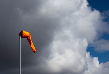 Airfield windsock, used to indicate wind speed and direction, shown deflated due to lack of wind