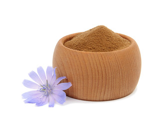 Chicory flower (cichorium intybus) and crushed chicory root in wooden bowl isolated on white...