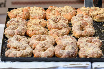 Large group of Romanian traditional food named martyrs (macinici, mucenici) with walnuts, sugar, honey and cinnamon for sale at a street food market