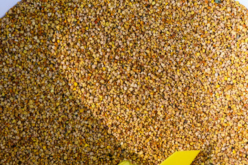 Close up of a large quantity of dried pollen available for sale at a street food market