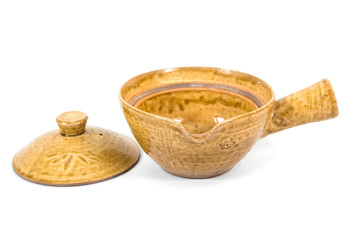 Opened ceramic bowl with cover and handle isolated on white background. Old pottery bowl with handle isolated