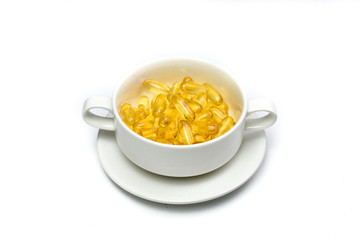 close up of salmon fish oil capsules isolated in white cup on white background. Salmon fish. Supplementary food. Omega 3. Vitamin E.