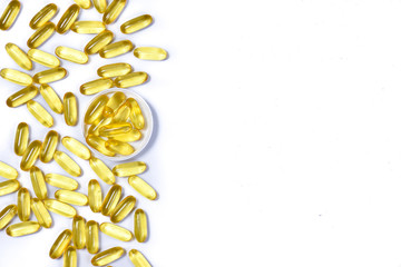 Top view of gold fish oil capsules isolated in white white background. Omega 3. Vitamin E. Supplementary food background. Salmon fish capsules view.