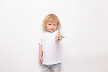 child playing with toy airplane against on a white background. concept dreams of flight