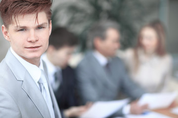 close up.the face of a serious young businessman on blurred background office