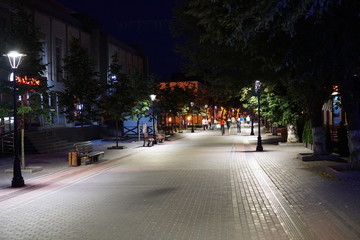 Fototapeta na wymiar Dark alley and light trails in Hanover, Pennsylvania at night.