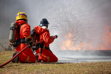 Firefighters are fighting fire with a  fire brigade