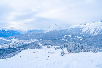 Fototapeta na wymiar Winter landscape with snow covered Alps, ski slopes and aerial view of Seefeld in the Austrian state of Tyrol. Winter in Austria