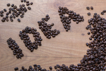 Conceptional sign IDEA drawn among brown roasted beans of coffee